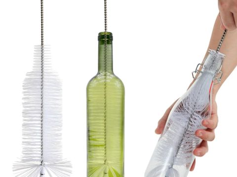Bottle cleaning brush beside a green glass bottle and a hand cleaning a bottle